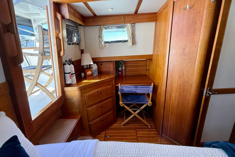 Destiny Yacht Photos Pics Cozy cabin interior of 1997 Sabreline 47 yacht with wooden furnishings and window view.