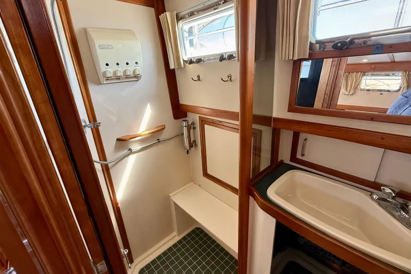 Destiny Yacht Photos Pics 1997 Sabre Sabreline 47 yacht bathroom with wooden accents and modern fixtures.