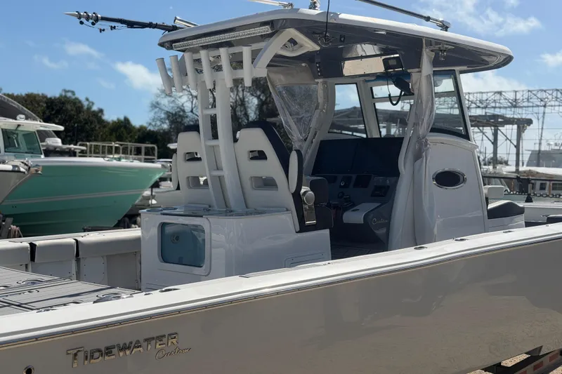  Yacht Photos Pics 2024 Tidewater 3100 Carolina Bay boat, sleek design, modern console, docked outdoors.