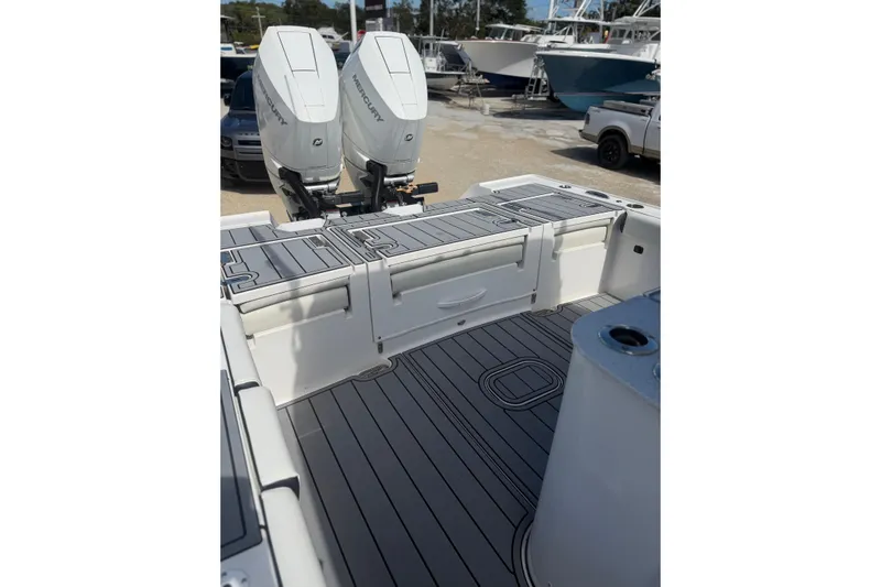  Yacht Photos Pics 2024 Tidewater 3100 Carolina Bay boat with dual Mercury engines, featuring sleek deck design.