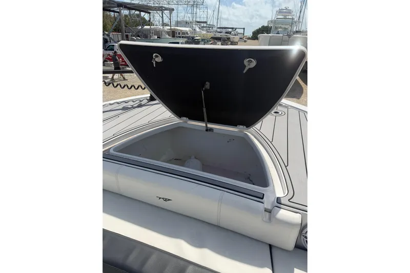  Yacht Photos Pics 2024 Tidewater 3100 Carolina Bay boat with open storage compartment on deck.