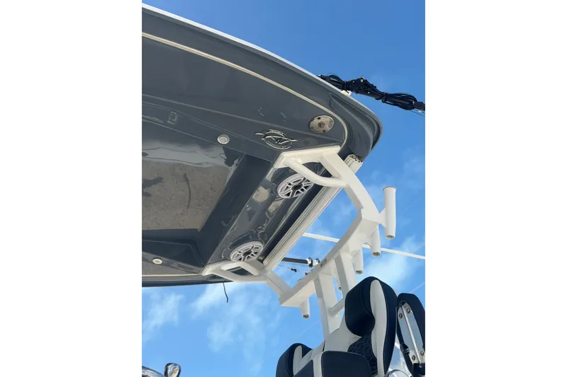  Yacht Photos Pics 2024 Tidewater 3100 Carolina Bay boat, featuring sleek design and modern equipment against a clear blue sky.