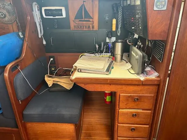 Exeter II Yacht Photos Pics Navigation station on a 1988 Sabre 38 sailboat with desk, electronics, and storage drawers.