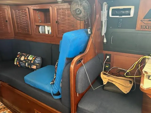 Exeter II Yacht Photos Pics Interior of 1988 Sabre 38 sailboat with blue cushions and wooden cabinetry.