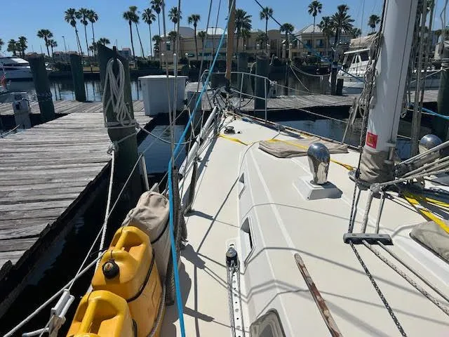 Exeter II Yacht Photos Pics 1988 Sabre 38 sailboat docked at marina with palm trees in background.
