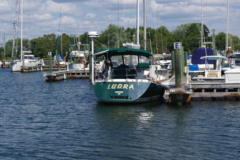 4869tw Yacht Photos Pics Boat docked at marina, Tartan 4100 model, 2001, surrounded by other vessels.