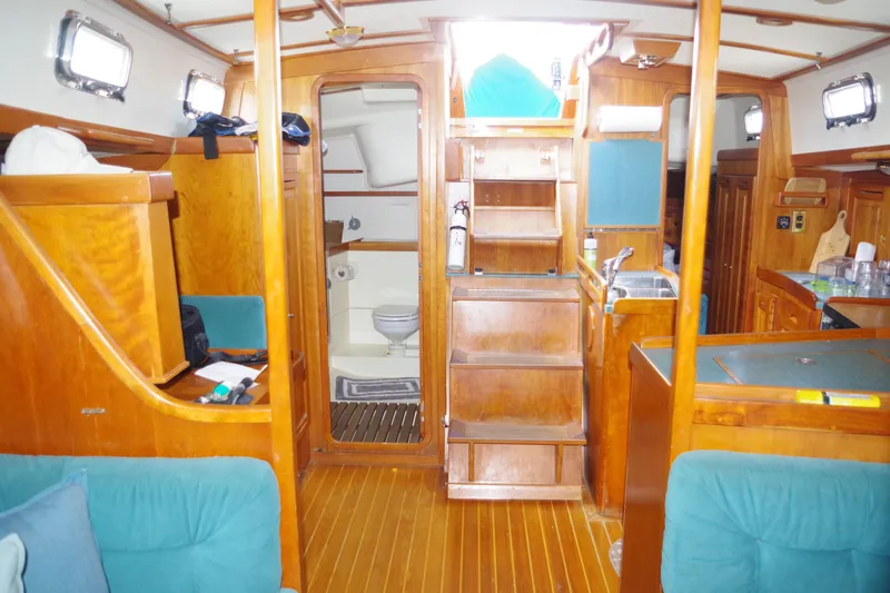 4869tw Yacht Photos Pics Interior of 2001 Tartan 4100 sailboat with wooden cabinetry and visible bathroom.
