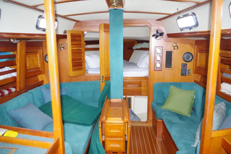 4869tw Yacht Photos Pics Interior of 2001 Tartan 4100 sailboat with cozy seating and wooden finishes.