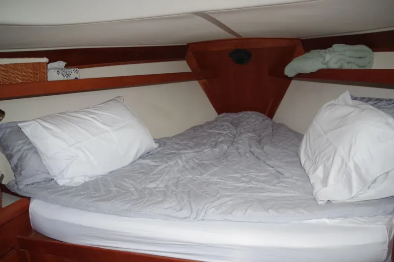 4869tw Yacht Photos Pics Cozy cabin bed in 2001 Tartan 4100 sailboat with pillows and blanket.