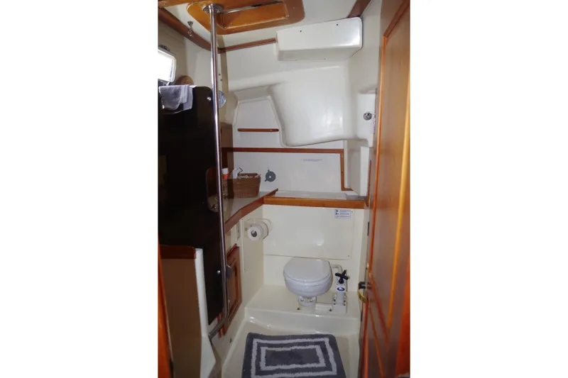 4869tw Yacht Photos Pics Interior of 2001 Tartan 4100 sailboat bathroom with toilet and storage.