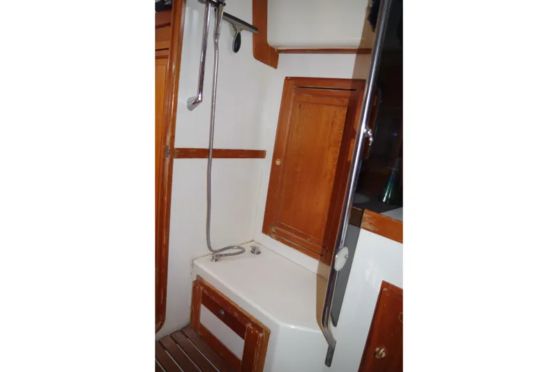4869tw Yacht Photos Pics 2001 Tartan 4100 yacht bathroom with wooden cabinetry and shower.