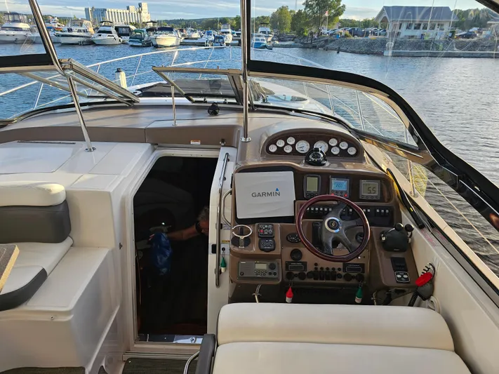 Yacht Photos Pics 2005 Regal Commodore 4260 yacht cockpit with Garmin navigation, docked at marina.