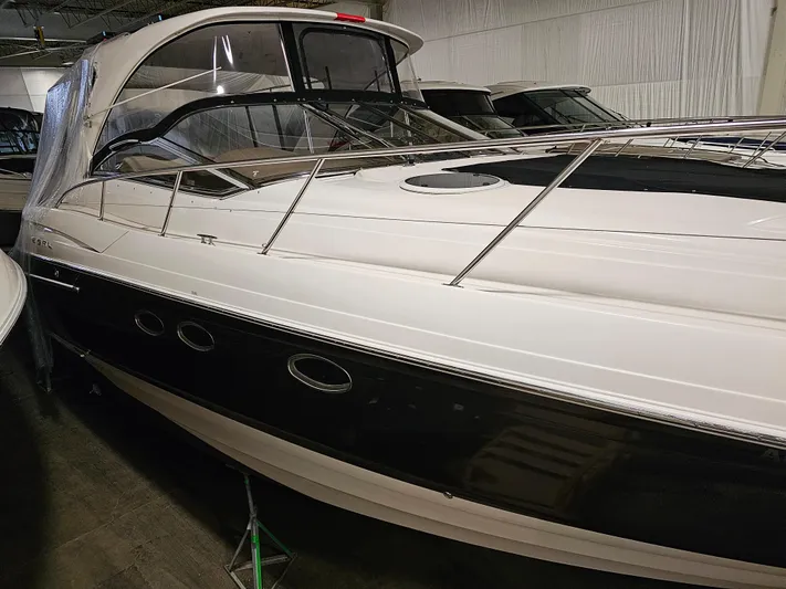  Yacht Photos Pics 2005 Regal Commodore 4260 yacht in storage, featuring sleek design and black hull.