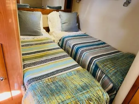 Yacht Photos Pics Twin beds with colorful striped blankets in a 2005 Regal Commodore 4260 cabin.