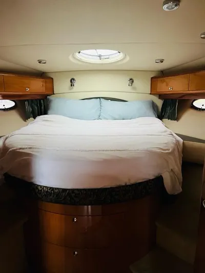  Yacht Photos Pics Luxurious cabin interior of 2005 Regal Commodore 4260 yacht with cozy bed and wooden accents.