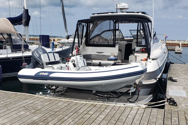  Yacht Photos Pics 2005 Regal Commodore 4260 yacht docked with inflatable boat on deck.
