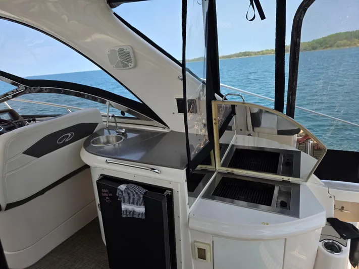  Yacht Photos Pics 2005 Regal Commodore 4260 yacht interior with kitchenette and ocean view.