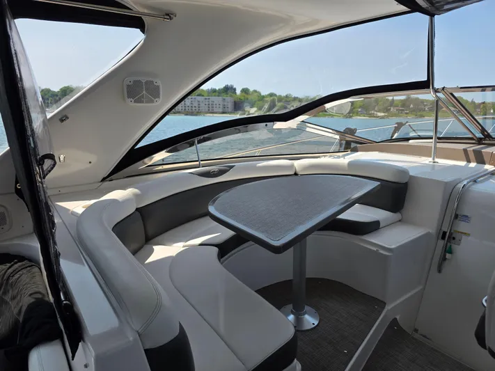  Yacht Photos Pics 2005 Regal Commodore 4260 yacht interior with seating and table, overlooking water.