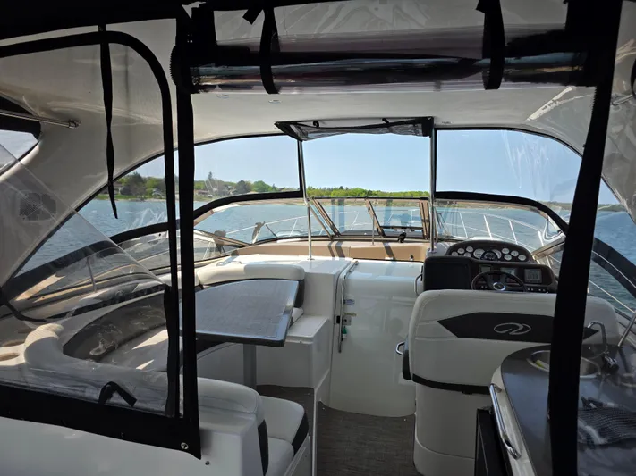  Yacht Photos Pics Interior view of 2005 Regal Commodore 4260 yacht with helm and seating area.