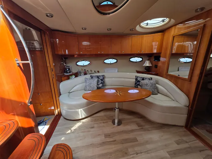  Yacht Photos Pics Luxurious interior of 2005 Regal Commodore 4260 yacht with elegant seating and wooden finishes.