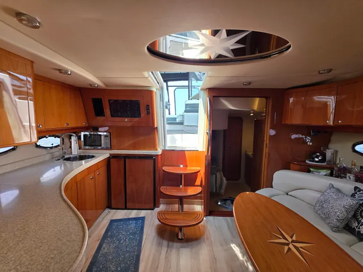  Yacht Photos Pics Luxurious interior of 2005 Regal Commodore 4260 yacht with wooden cabinetry and modern amenities.