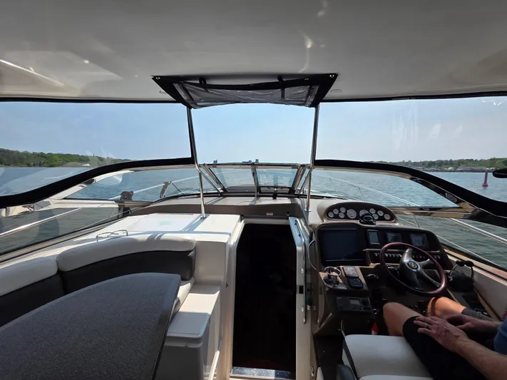  Yacht Photos Pics Interior view of 2005 Regal Commodore 4260 yacht cockpit with steering controls and seating.