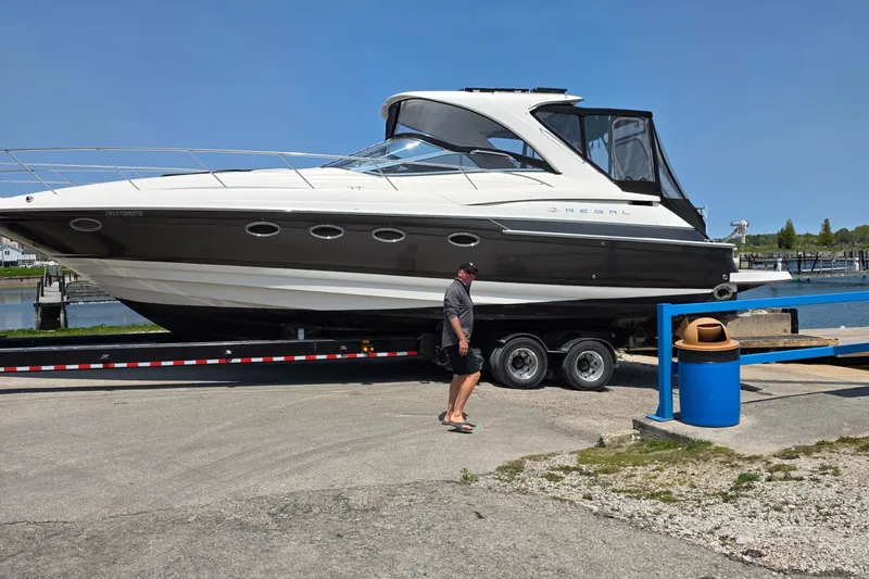 Yacht Photos Pics 2005 Regal Commodore 4260 yacht on trailer at marina, clear sky background.