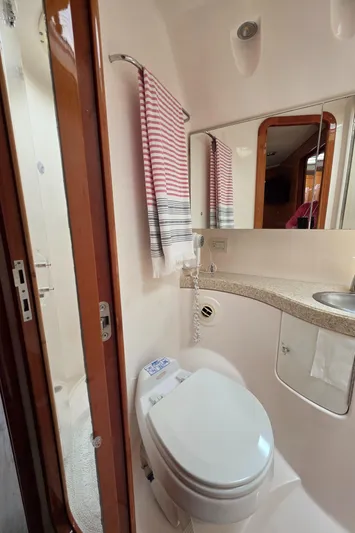  Yacht Photos Pics 2005 Regal Commodore 4260 yacht bathroom with modern fixtures and striped towel.