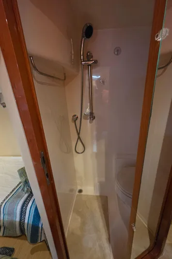  Yacht Photos Pics 2005 Regal Commodore 4260 yacht bathroom with shower and wooden accents.