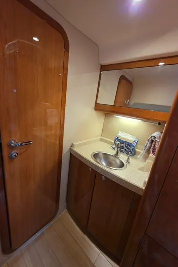  Yacht Photos Pics 2005 Regal Commodore 4260 yacht bathroom with wooden cabinetry and stainless steel sink.