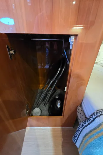  Yacht Photos Pics Open cabinet in 2005 Regal Commodore 4260 yacht interior, showing storage space.