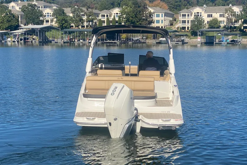 Yacht Photos Pics 2022 Sea Ray SDX 270 Outboard boat on a serene lake with waterfront homes.
