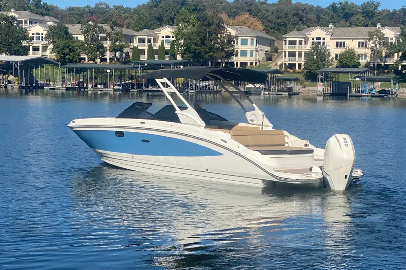  Yacht Photos Pics 2022 Sea Ray SDX 270 Outboard boat on a serene lake with waterfront homes.