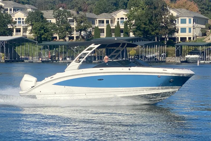  Yacht Photos Pics 2022 Sea Ray SDX 270 Outboard cruising on a lake near waterfront homes.