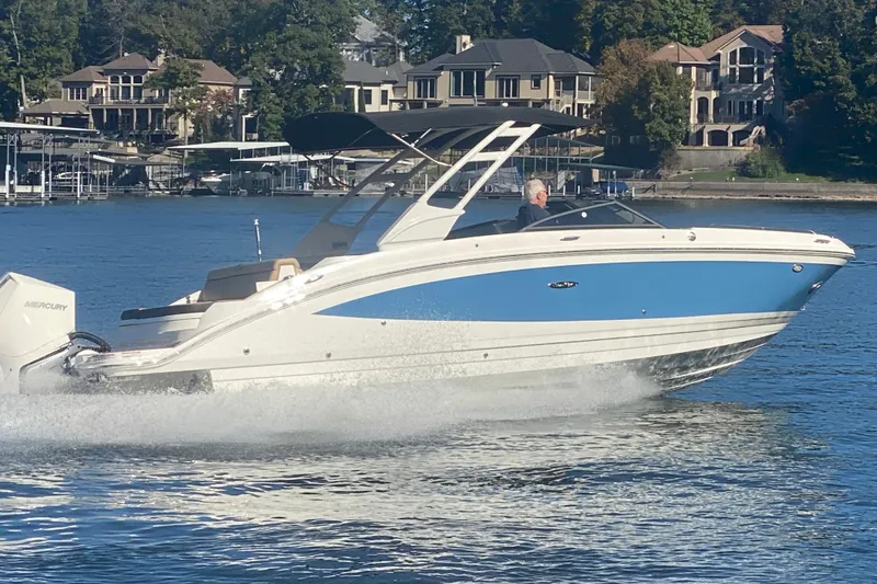  Yacht Photos Pics 2022 Sea Ray SDX 270 Outboard cruising on a lake with waterfront homes in the background.