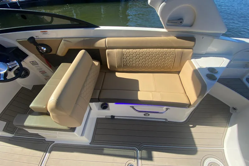 Yacht Photos Pics 2022 Sea Ray SDX 270 Outboard boat interior with tan seating and cup holders.