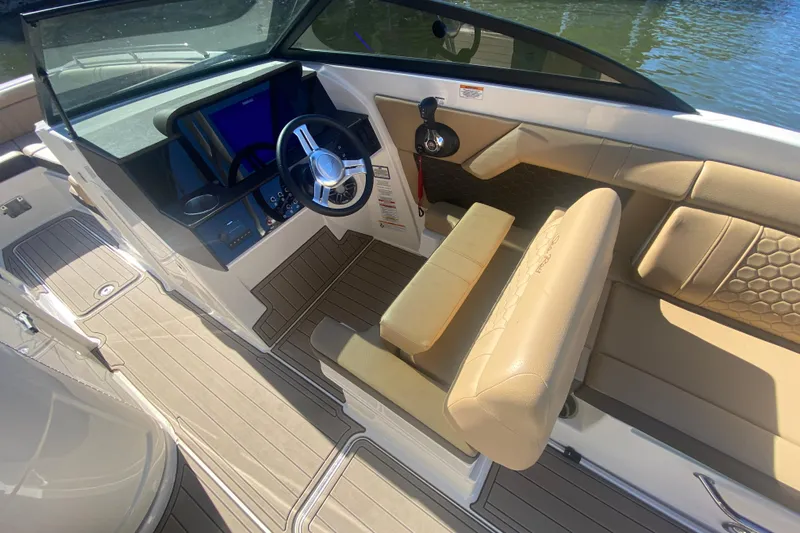  Yacht Photos Pics 2022 Sea Ray SDX 270 Outboard boat interior with beige seating and modern dashboard.