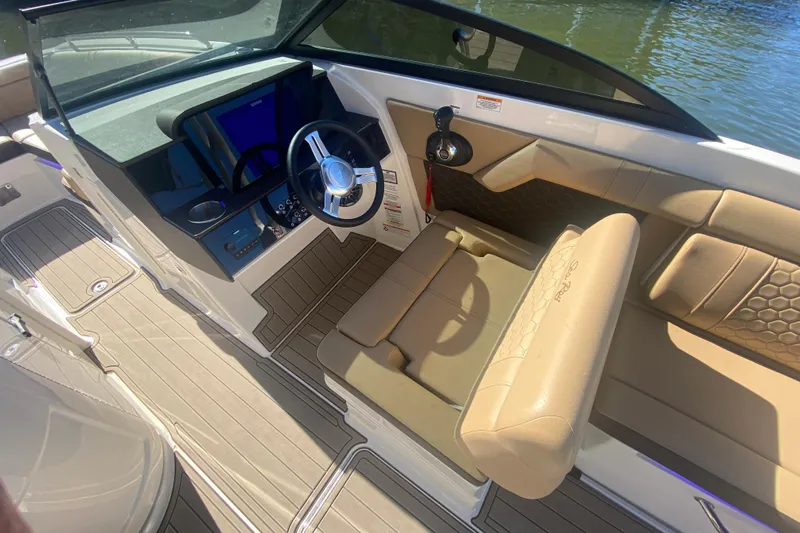  Yacht Photos Pics 2022 Sea Ray SDX 270 Outboard boat interior with beige seating and modern dashboard.