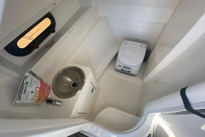  Yacht Photos Pics 2022 Sea Ray SDX 270 Outboard boat bathroom with sink and portable toilet.