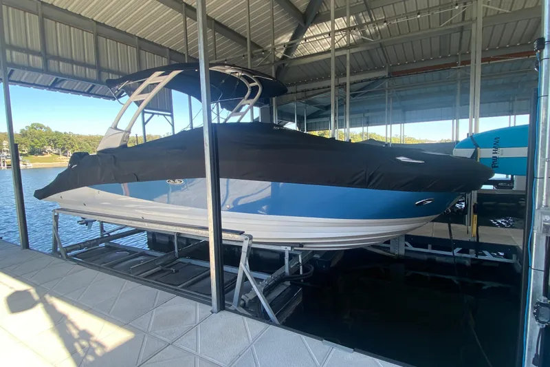  Yacht Photos Pics 2022 Sea Ray SDX 270 Outboard boat docked under a covered marina.