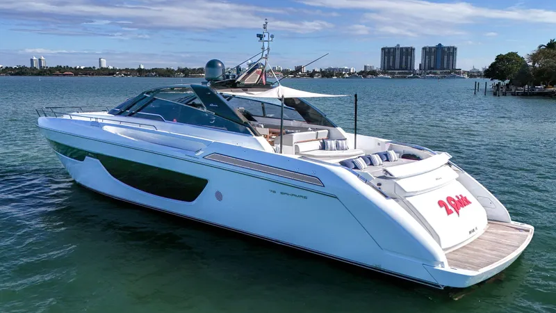  Yacht Photos Pics 2018 Riva 76' Bahamas luxury yacht on serene water with city skyline.