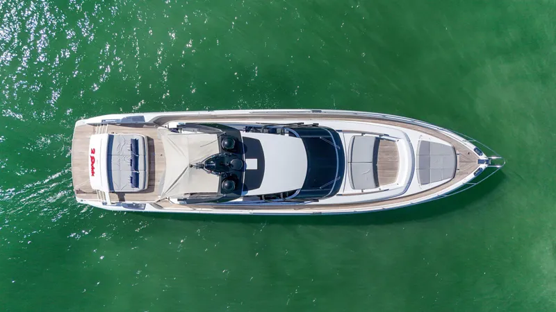  Yacht Photos Pics Aerial view of 2018 Riva 76' Bahamas yacht on green water.