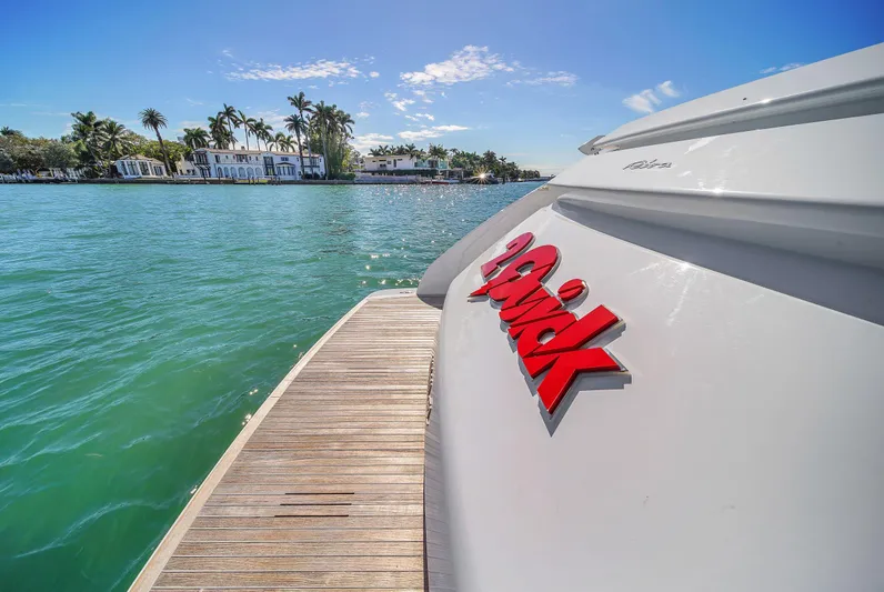  Yacht Photos Pics Riva 76' Bahamas yacht, 2018 model, docked by tropical waterfront homes.