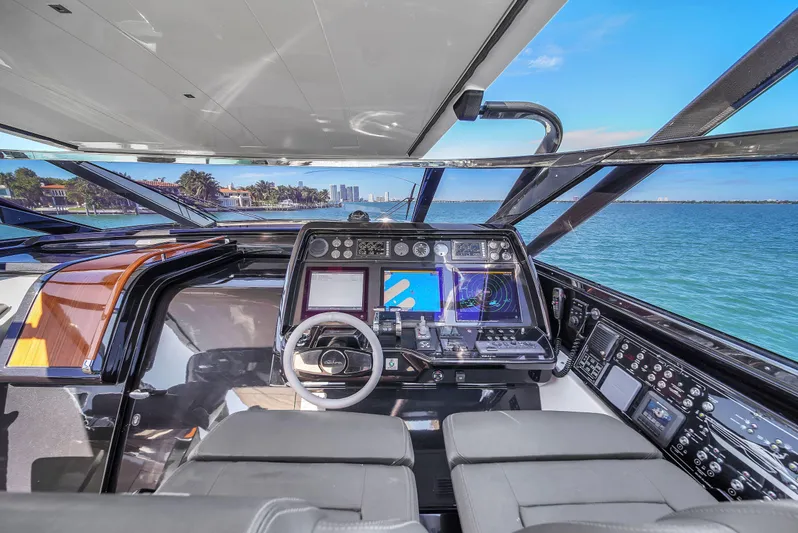 Yacht Photos Pics Interior view of 2018 Riva 76' Bahamas yacht cockpit with ocean backdrop.