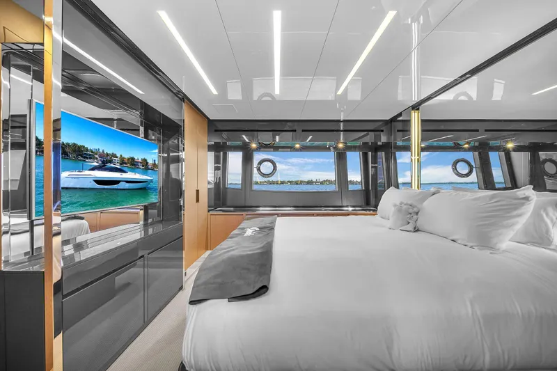  Yacht Photos Pics Luxurious bedroom interior of 2018 Riva 76' Bahamas yacht with modern design and large windows.