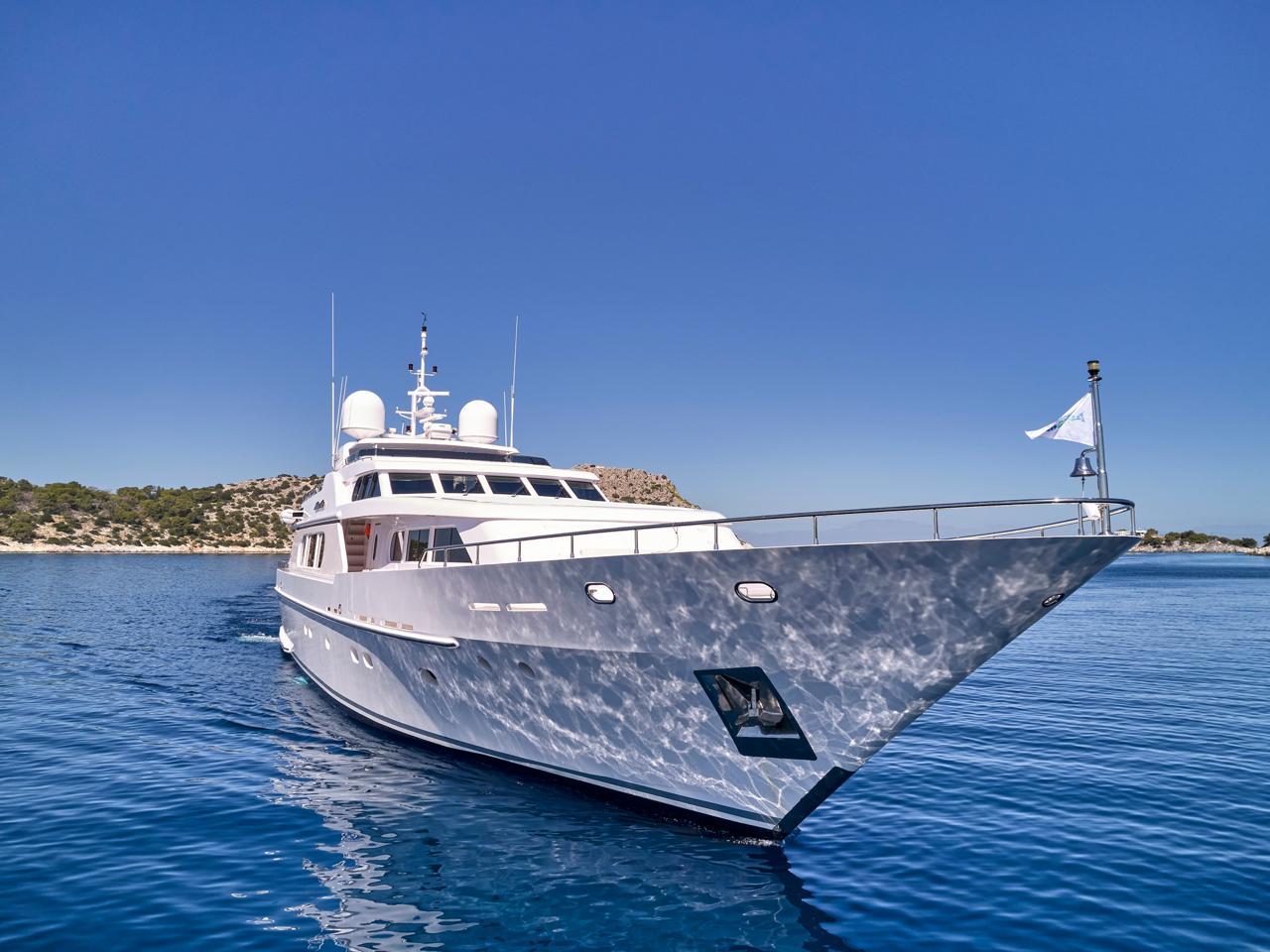Luxury Codecasa 115 yacht from 2000 on clear blue water, sunny day.