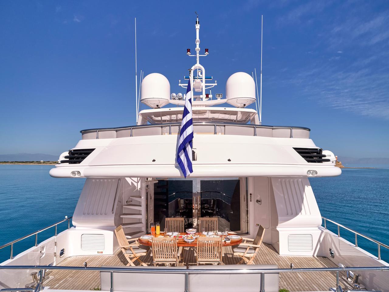 Luxury Codecasa 115 yacht from 2000, featuring elegant outdoor dining area on deck.