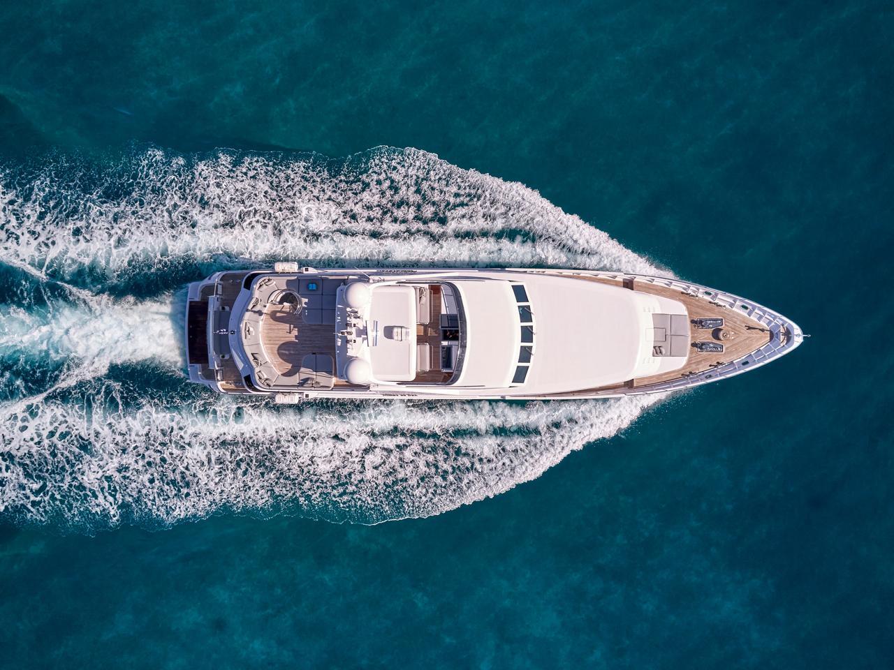 Aerial view of Codecasa 115 yacht cruising on blue ocean waters, 2000 model.