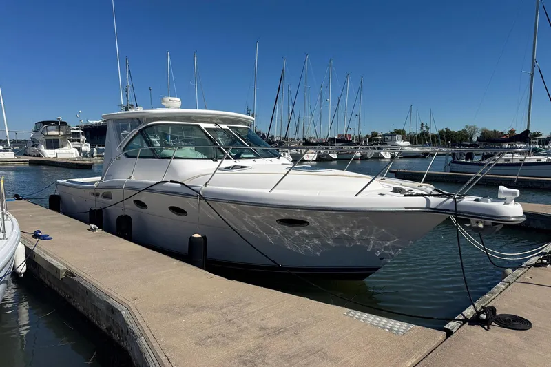 Lone Star Yacht Photos Pics 2005 Tiara Yachts 3200 Open docked at marina, surrounded by sailboats under clear blue sky.