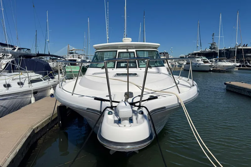 Lone Star Yacht Photos Pics 2005 Tiara Yachts 3200 Open docked in a marina, surrounded by other boats.